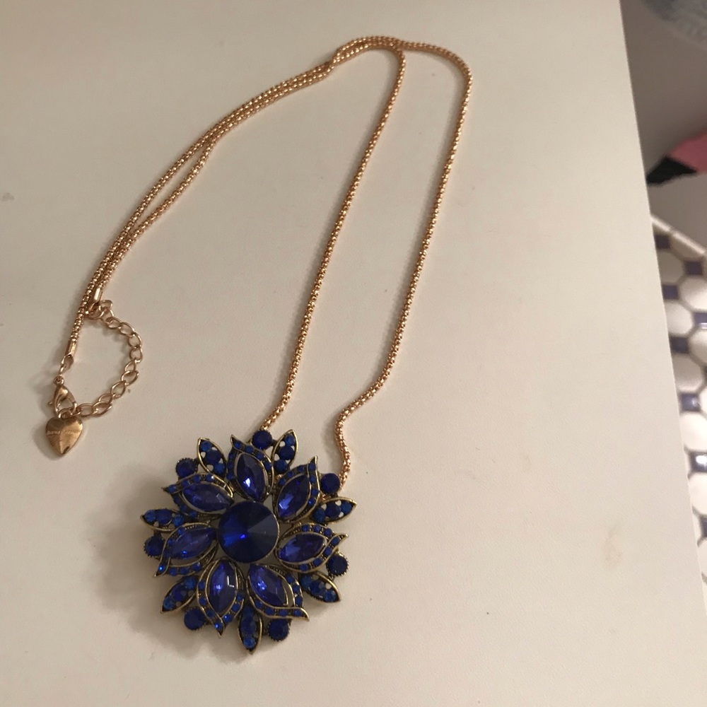 Betsy Johnson necklace it has a blue stone flower in the middle.
